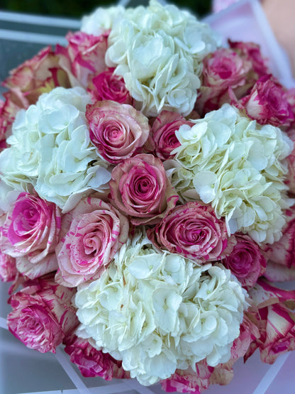 A bouquet of roses and hydrangeas