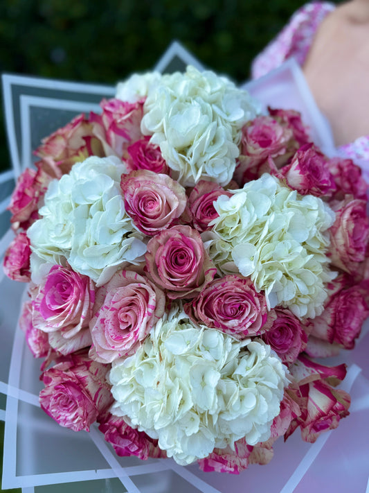 A bouquet of roses and hydrangeas